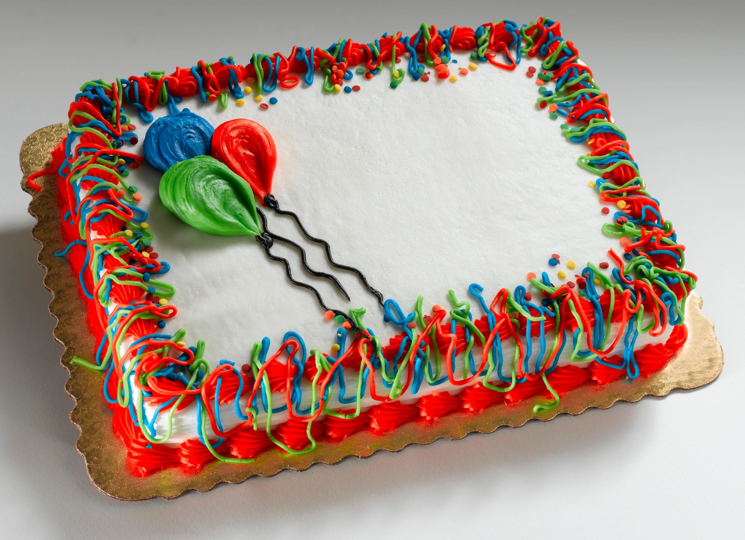 Simple frosted birthday cake on a white background