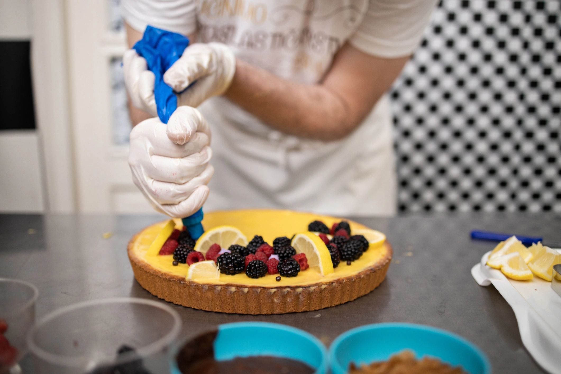 Chef adding cream to a cake