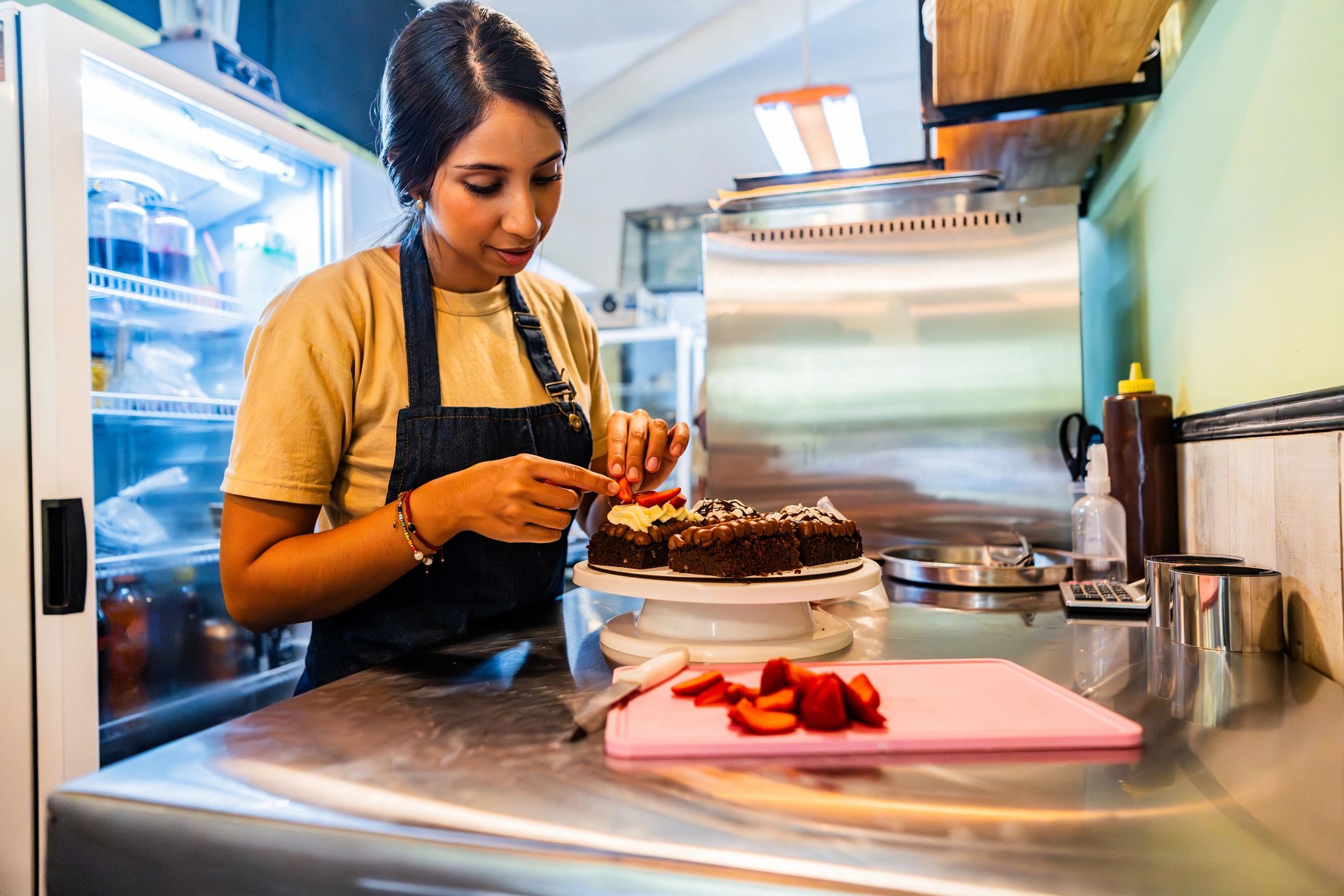 Baker preparing a cake in a professional kitchen