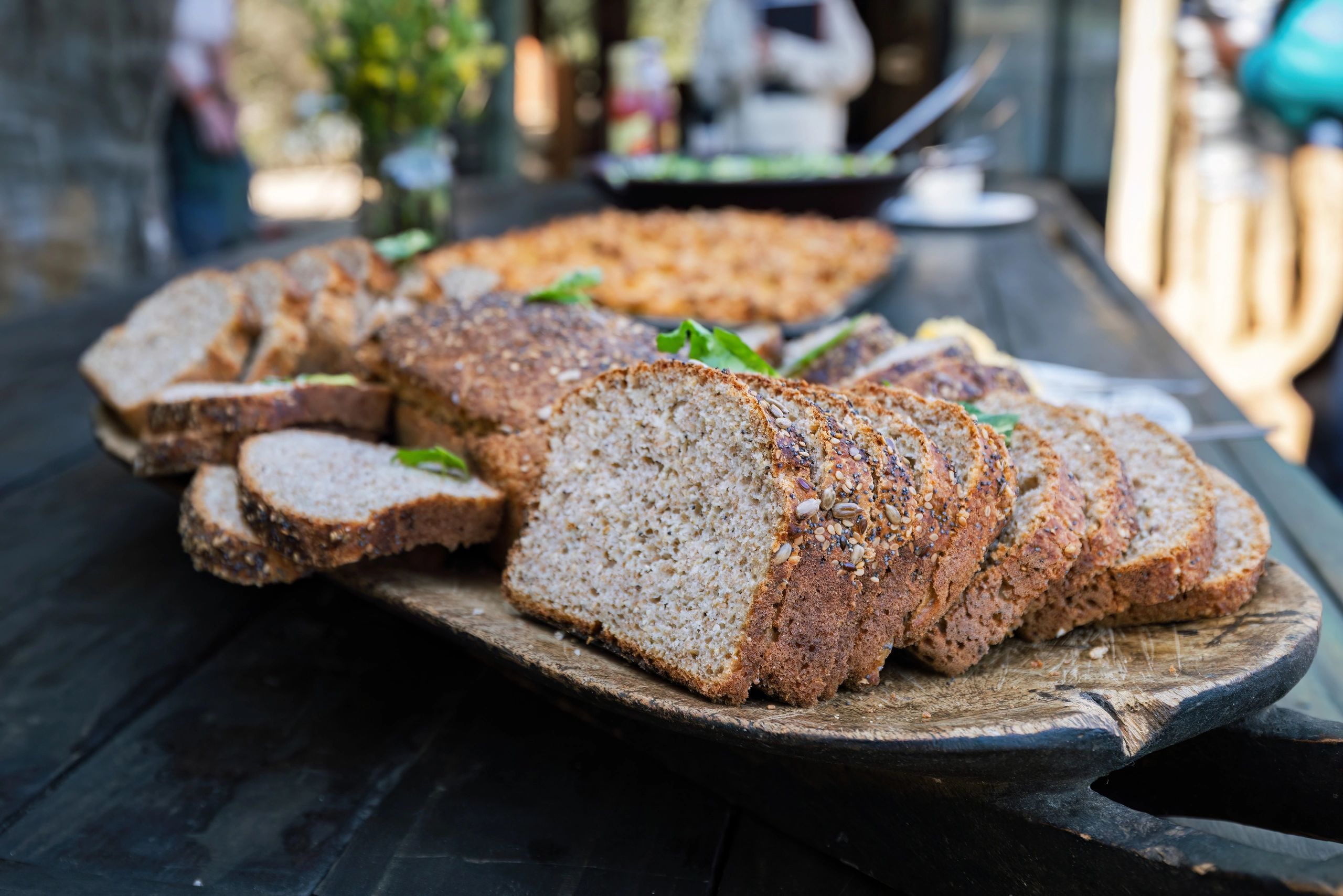 Fresh sliced bread arranged on a wooden board