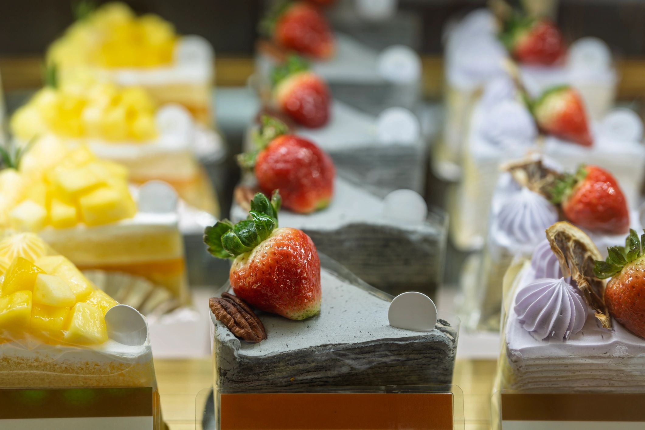Assorted cake slices with fruit toppings